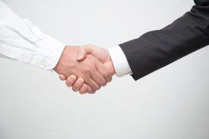 client and defense lawyer shaking hands